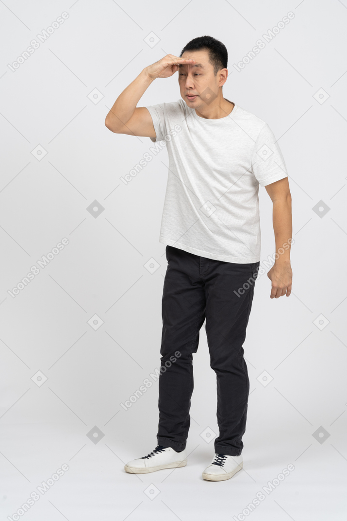 Front view of a man in casual clothes looking for someone