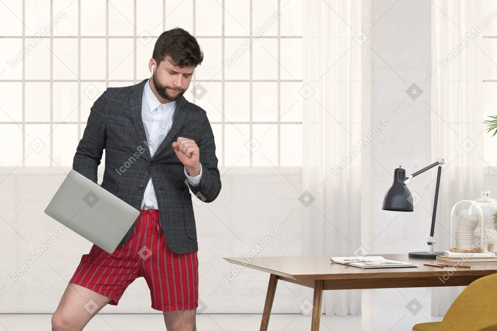 A man in shorts and a blazer is holding a laptop