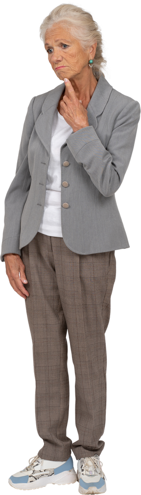 Front view of a thoughtful old lady in suit