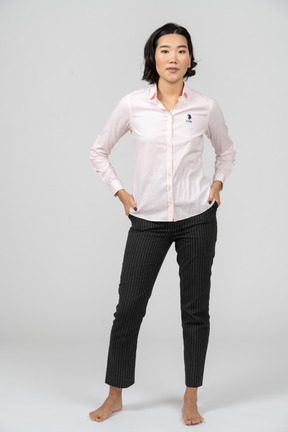 Woman in office clothes posing with hands on hips
