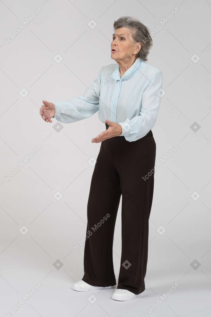 Three-quarter view of an old woman gesturing expressively