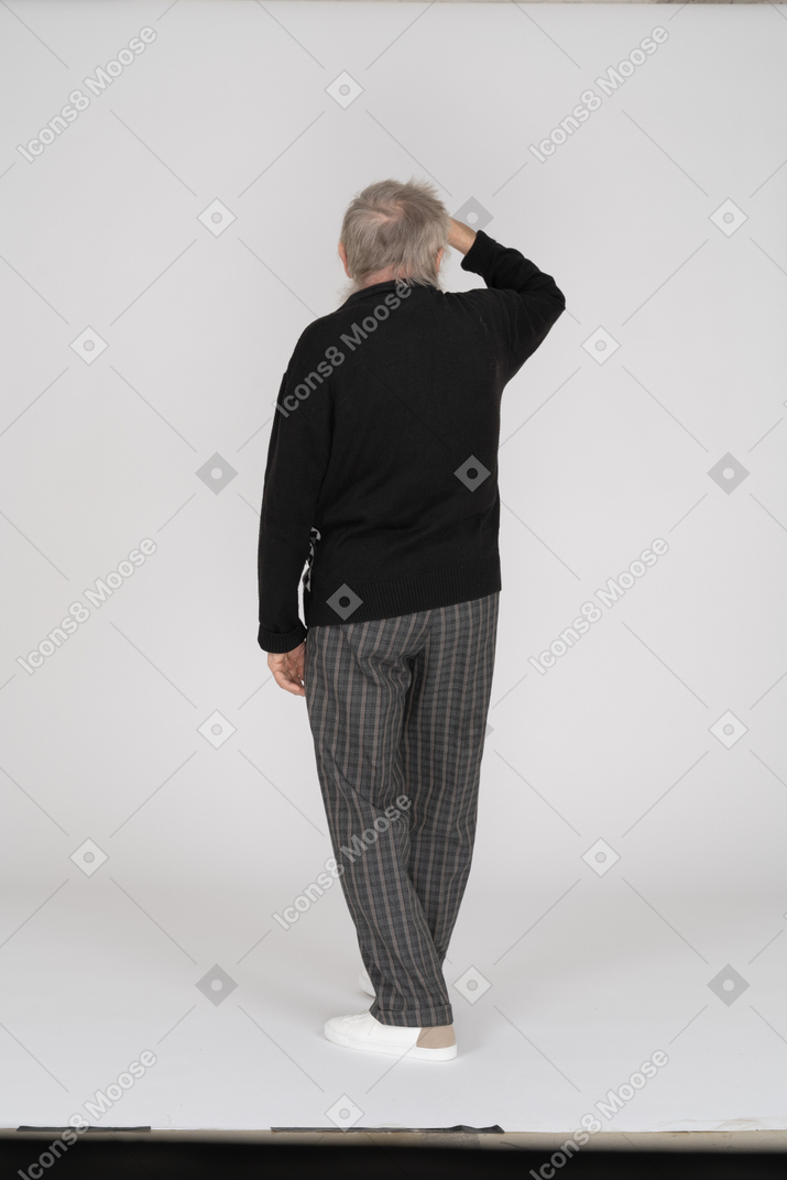 Rear view of old man looking into distance