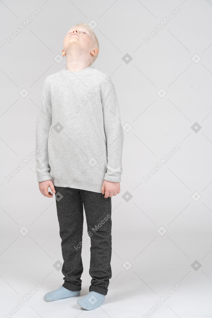 Front view of a kid boy raising his head