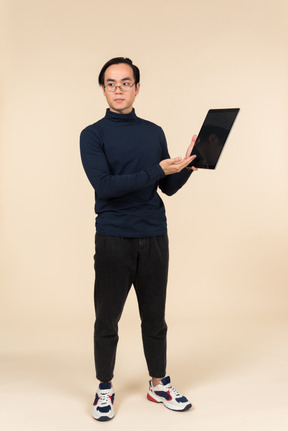 Young asian man presenting a digital tablet