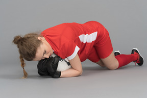 A female goalkeeper catching a ball