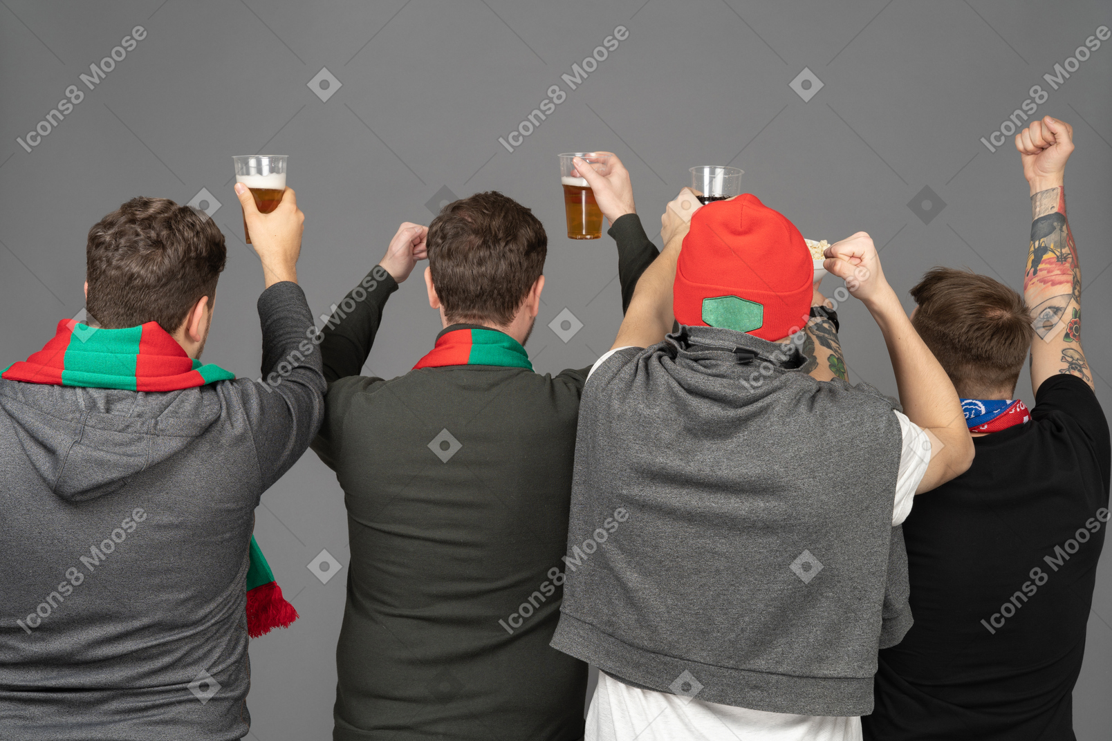Back view of four male football fans celebrating the victory & holding beer