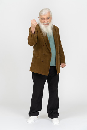 Portrait of an elderly man angrily shaking his fist