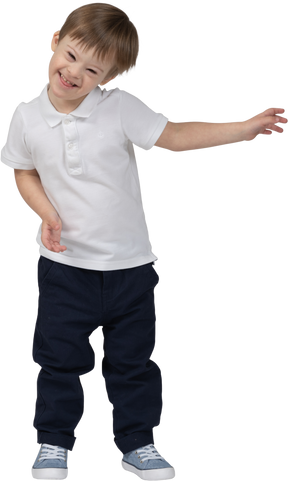 Front view of a boy waving hands and laughing