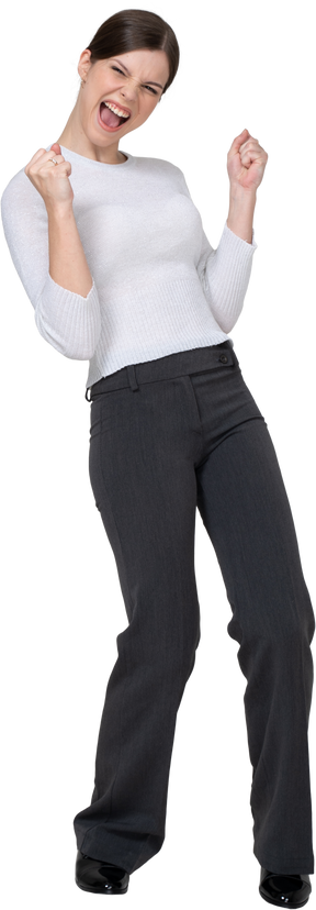 Front view of a delighted young woman in office clothing