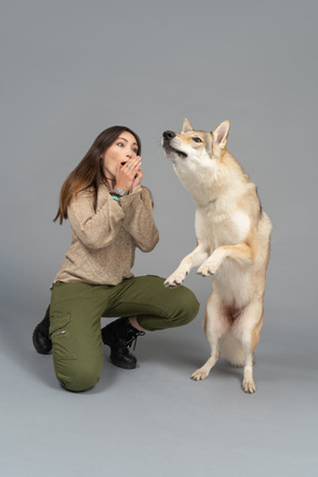 Mulher jovem e bonita e seu cachorro estar intrigado