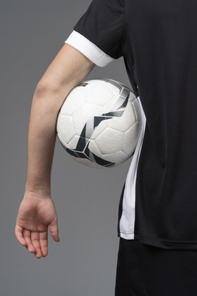 Close-up of a soccer player holding a ball