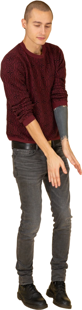 Three-quarter view of a dancing young man dressed in red pullover