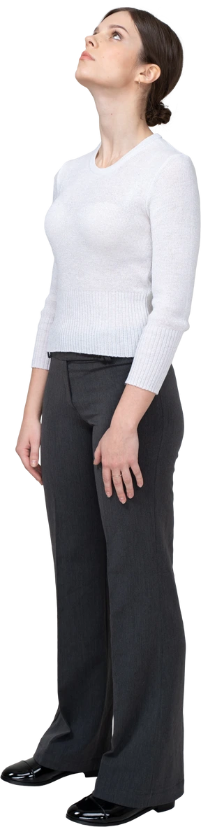 Three-quarter view of a young woman in office clothing looking down