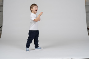 Little boy laughing and pointing at something