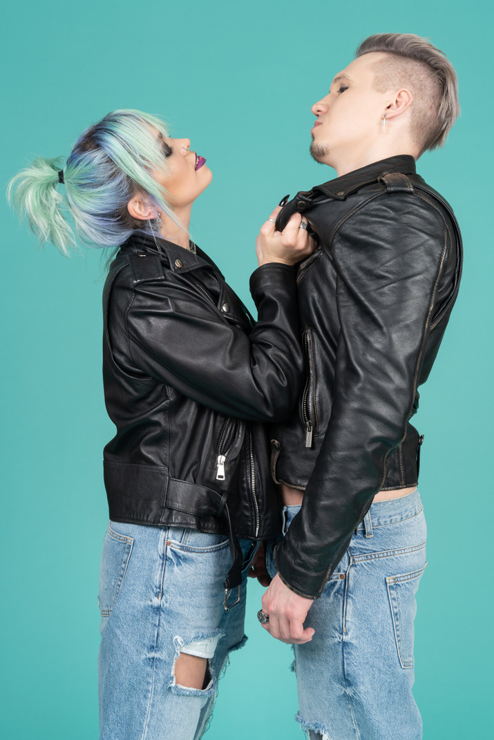 Young woman with turquoise hair hoisting her boyfriend