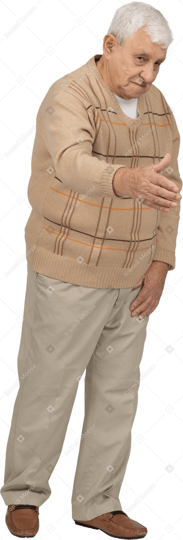 Front view of an old man in casual clothes giving a hand for shake