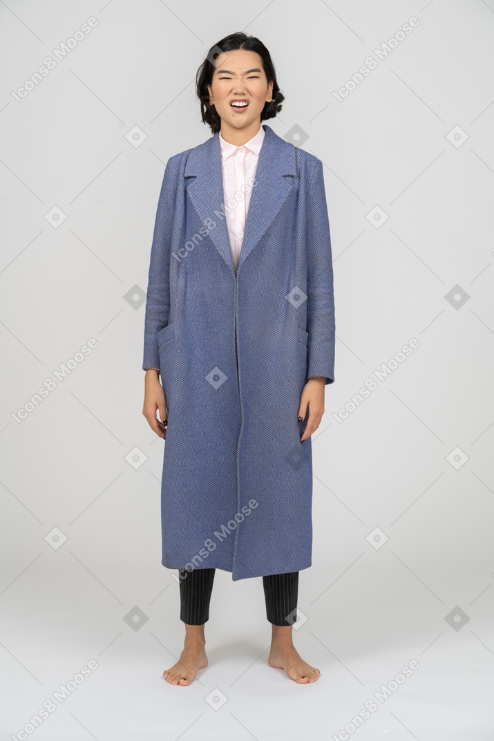 Woman in blue coat looking disgusted