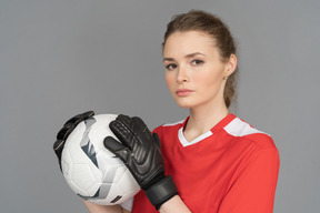 A beautiful sporty woman holding a ball