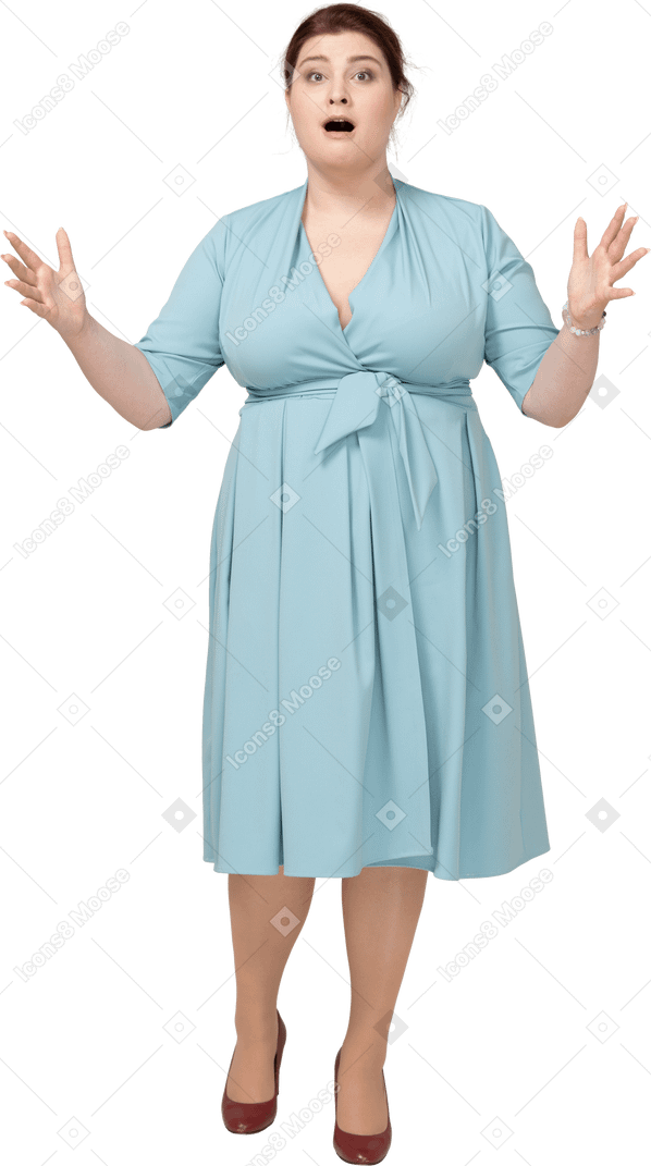 Front view of a shocked woman in blue dress looking at camera