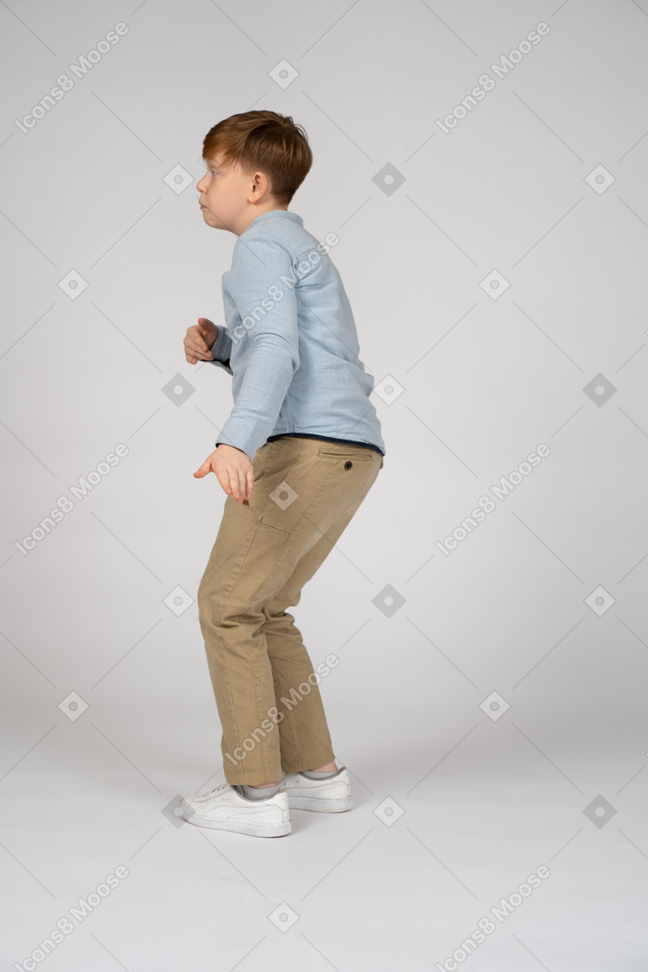 Side view of a young boy dancing