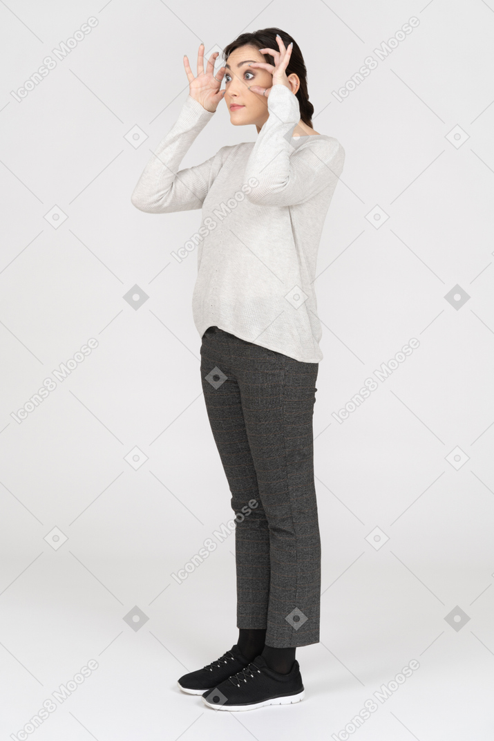 Woman looking through imaginary binoculars