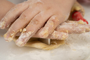 Cutting out gingerbread cookie