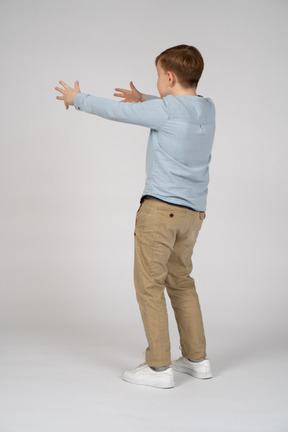 Boy outstretching his arms forward