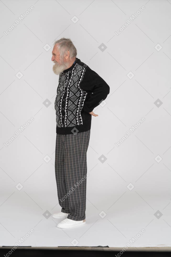 Side view of old man suffering from back pain