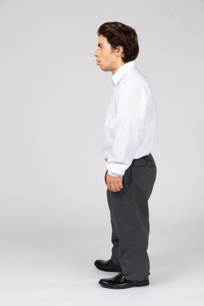 Side view of a surprised male office worker looking away