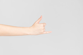 Side look of female hand with big and little finger up