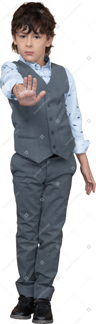 Front view of a boy in grey suit making stop gesture