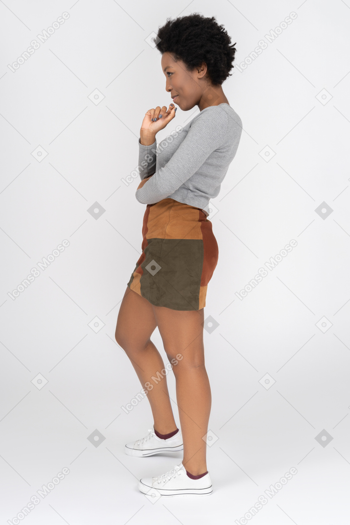 Cheerful african girl posing sideways