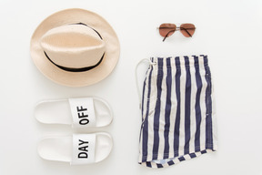 Bathing shorts, beach slippers, hat and sunglasses