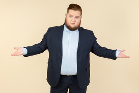 Young overweight man in suit showing ok gesture with both hands