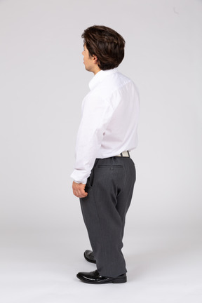 Back view of male white collar worker looking away