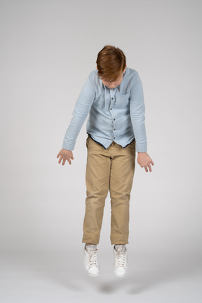 A boy jumping and looking down