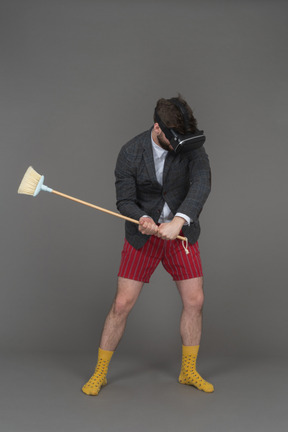 Man in vr headset with a broom