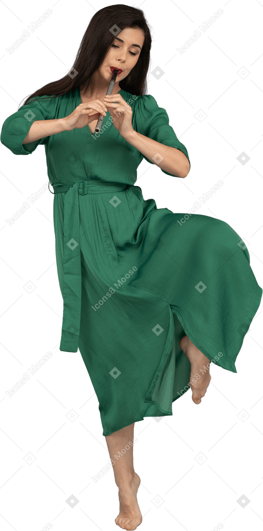 Front view of a dancing young lady in green dress playing flute