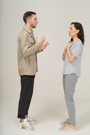 Side view of young couple speaking to each other