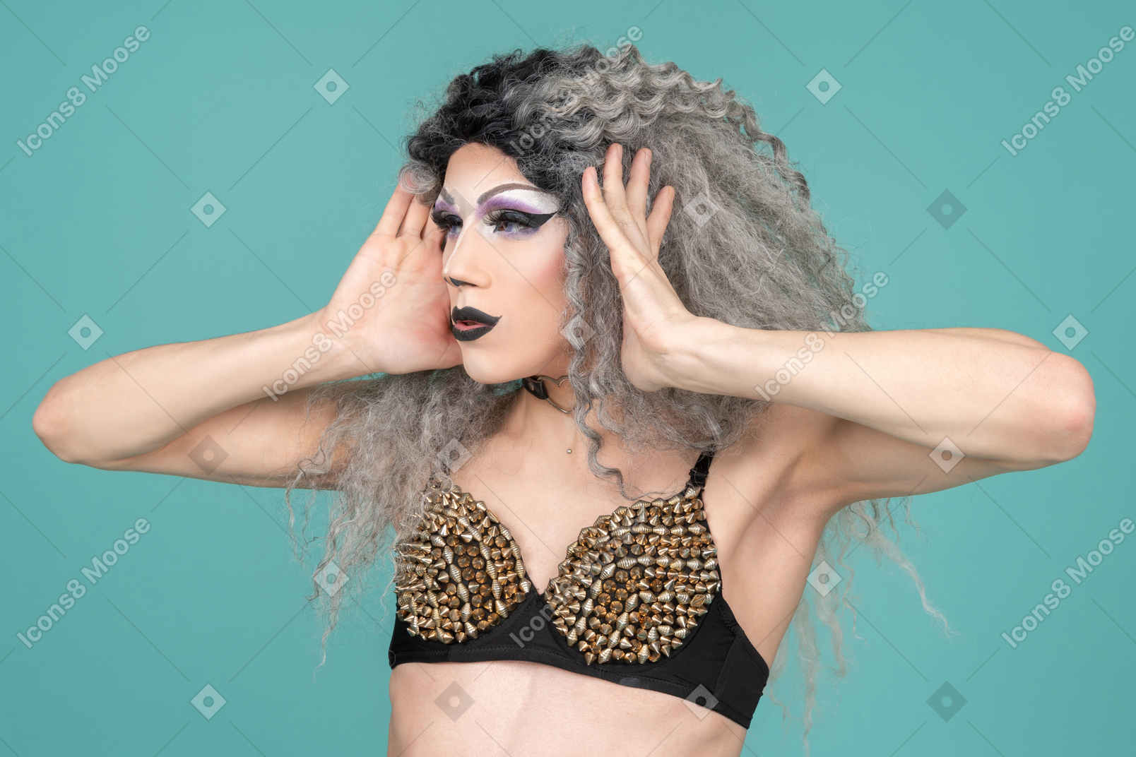 Drag queen holding their face with both hands