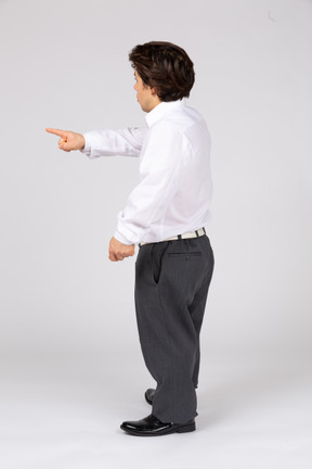 Side view of man in white shirt pointing