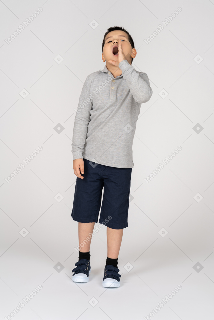 Front view of a boy calling for someone