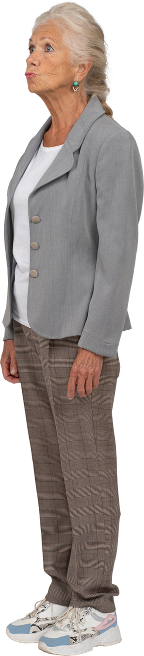 Side view of an old lady in suit making faces