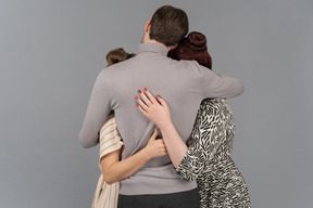 Warm embraces from two young women and one young man