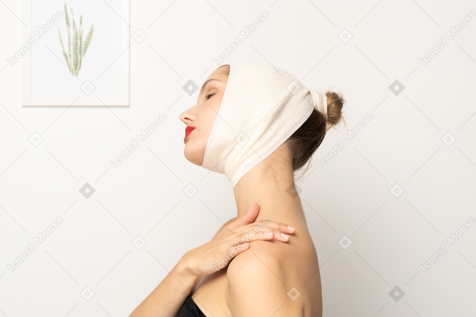 Woman with head bandage touching her shoulder
