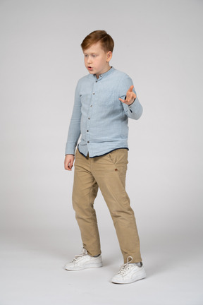 Boy in a blue shirt talking and gesturing