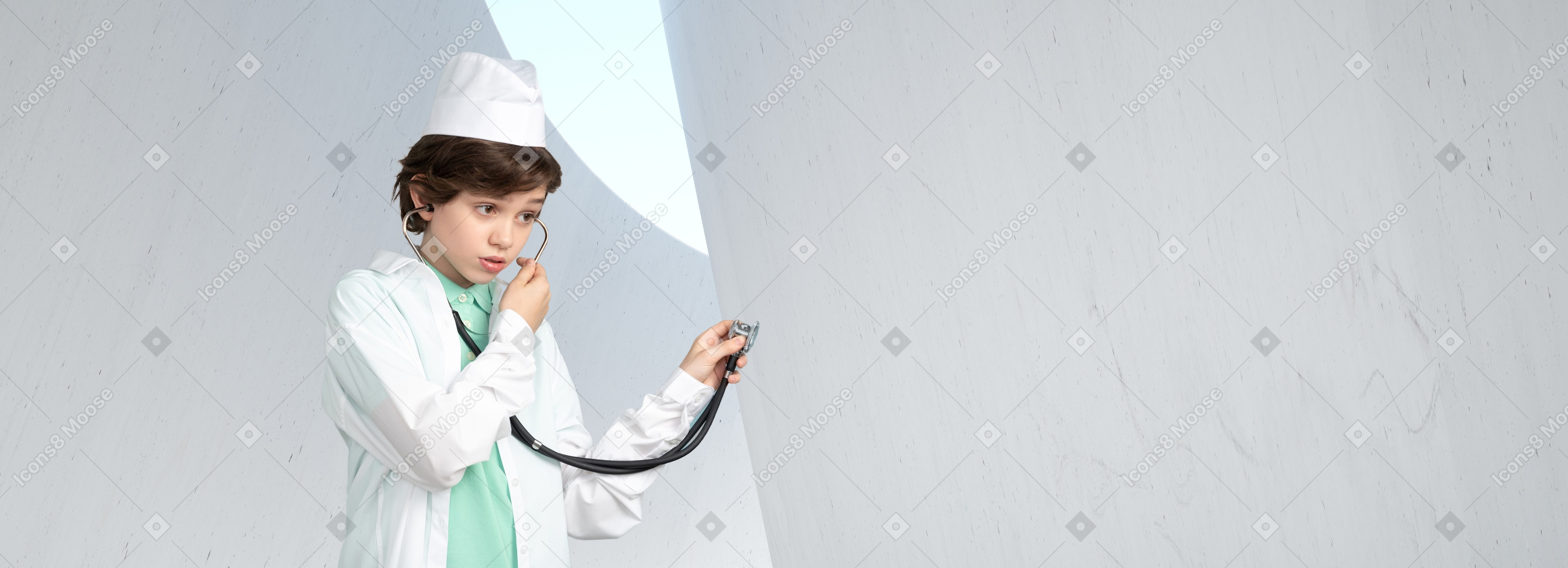 A young boy dressed in a doctor's outfit holding a stethoscope