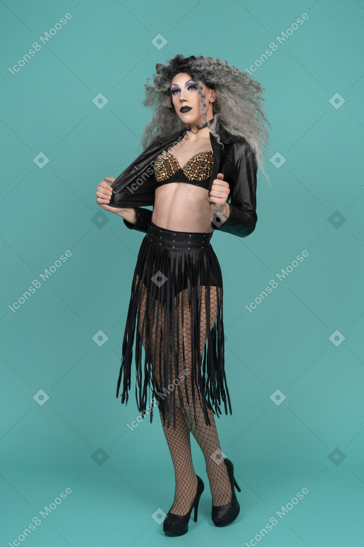 Drag queen opening jacket while posing