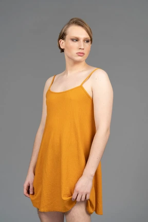 Genderqueer person standing with arms at sides