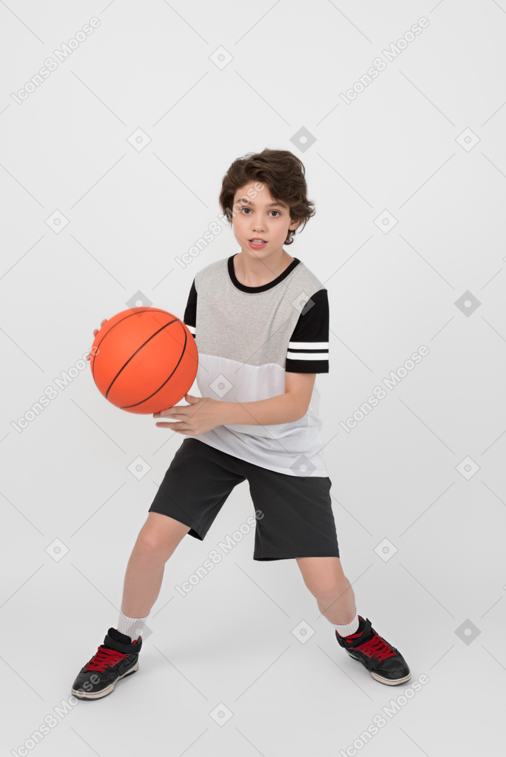 Boy is ready to pass the basketball ball